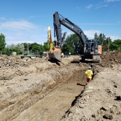 Valley park branch construction outside pictured with a worker in a trench in front of a machine