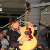 a photo of a guy playing the guitar