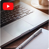 Laptop with a YouTube icon in the top left