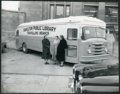 History of the Bookmobile Archival photo of three women, including Chief Librarian Freda Waldon, leaning against the Hamilton Public Library Bookmobile, December 4, 1956
